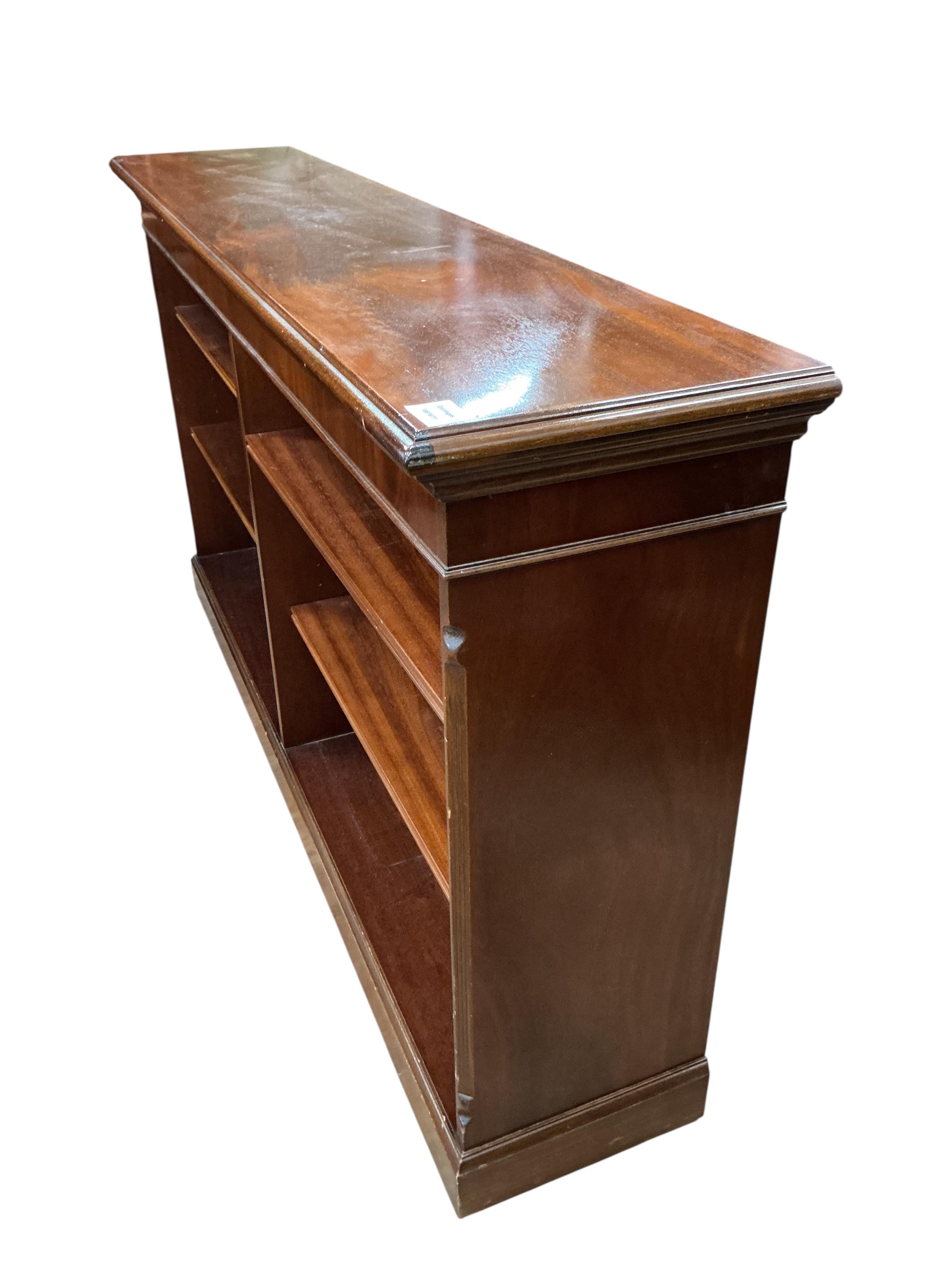 A reproduction mahogany dwarf open bookcase, width 152cm, depth 32cm, height 86cm